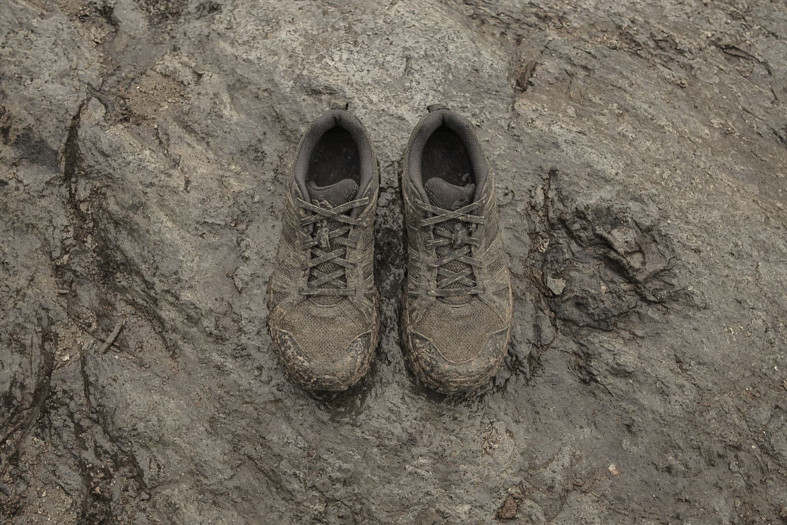 Wide toe-box trail shoes on wet slab rock, seen from above