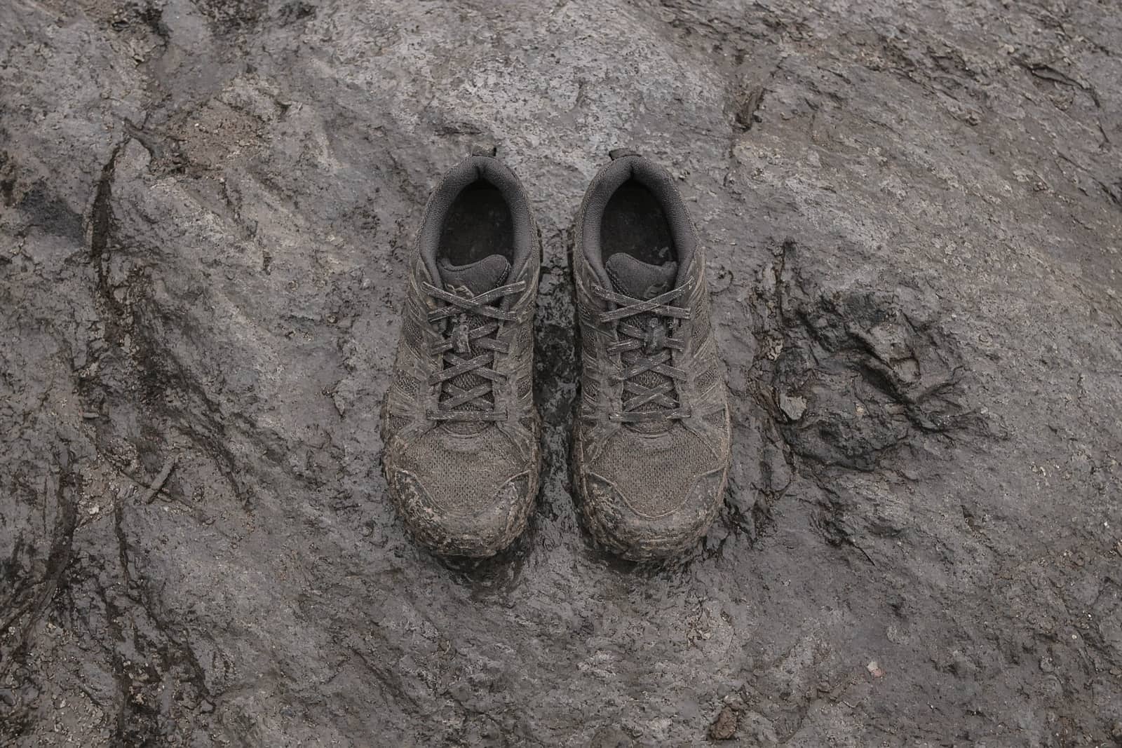 Wide toe-box trail shoes on wet slab rock, seen from above