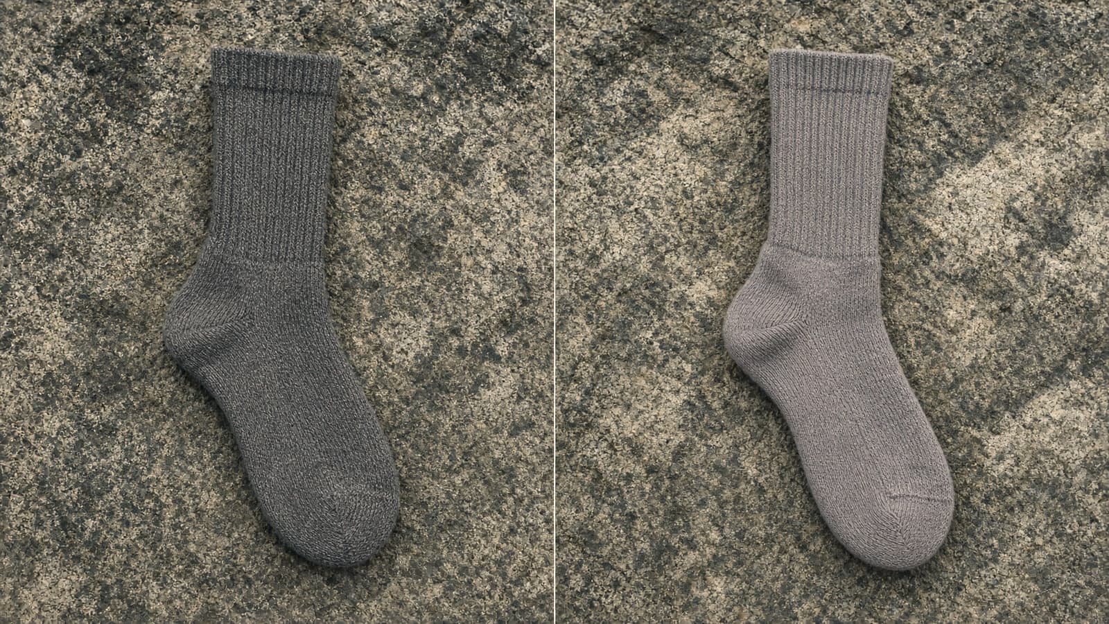 A dense-knit crew hiking sock beside a cushioned crew merino sock, granite slab