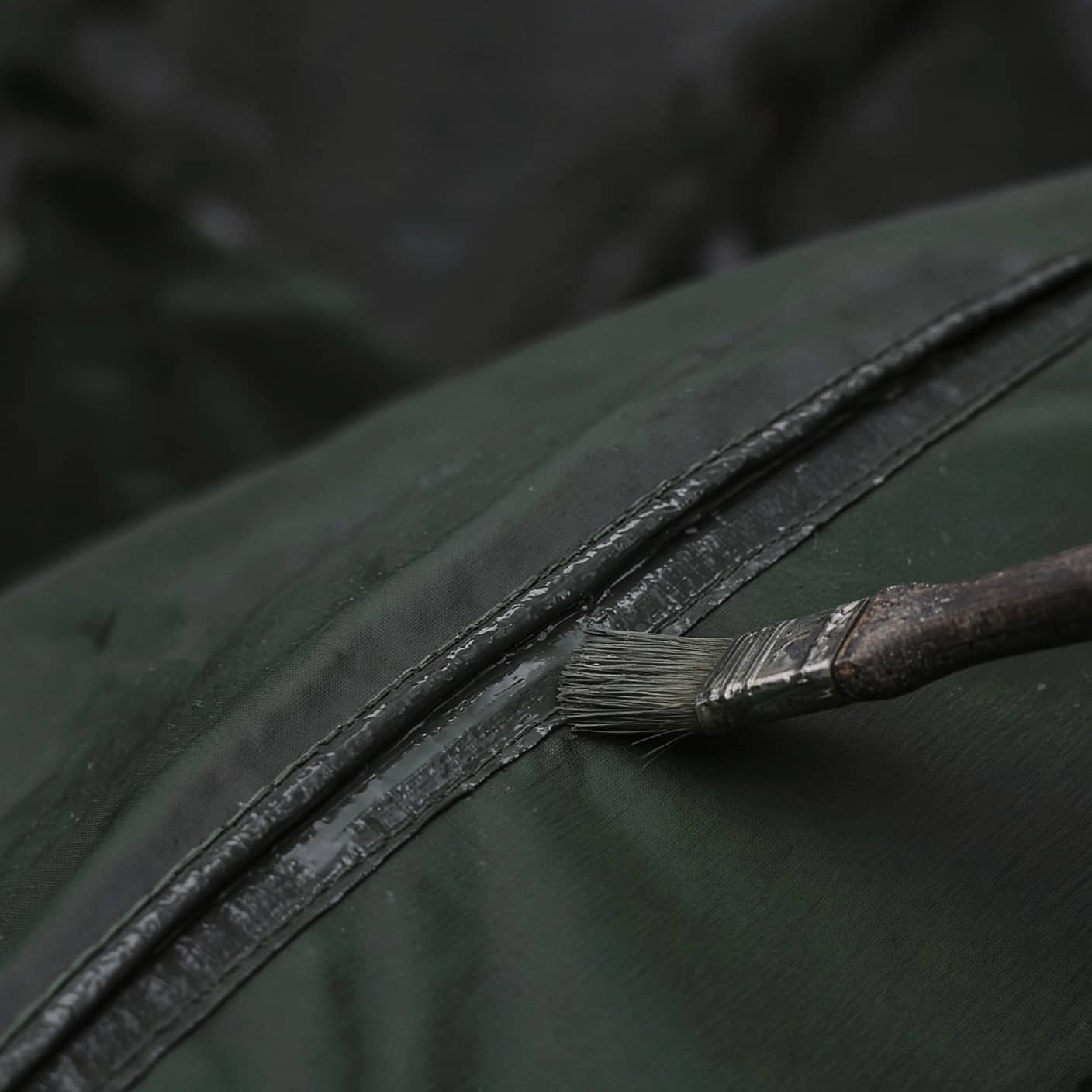 A small brush sealing a tent seam, macro