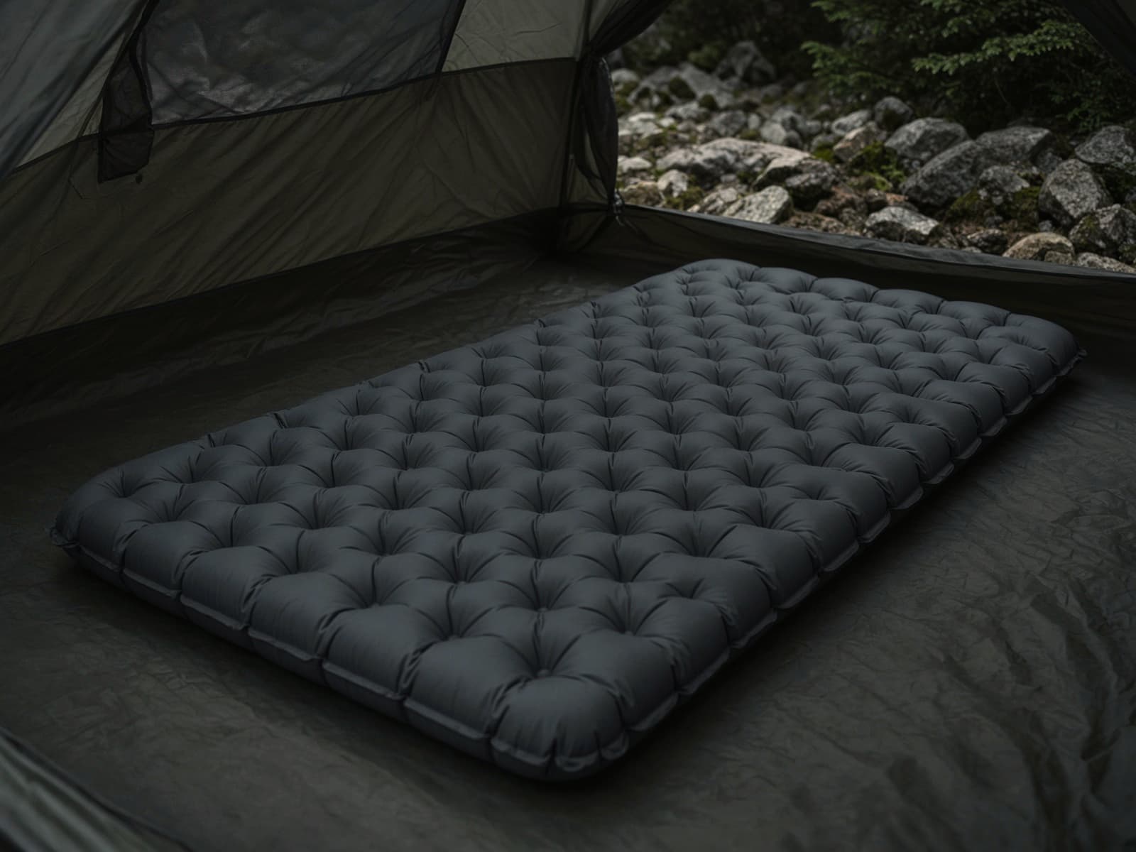 A very thick camp air pad on a tent floor