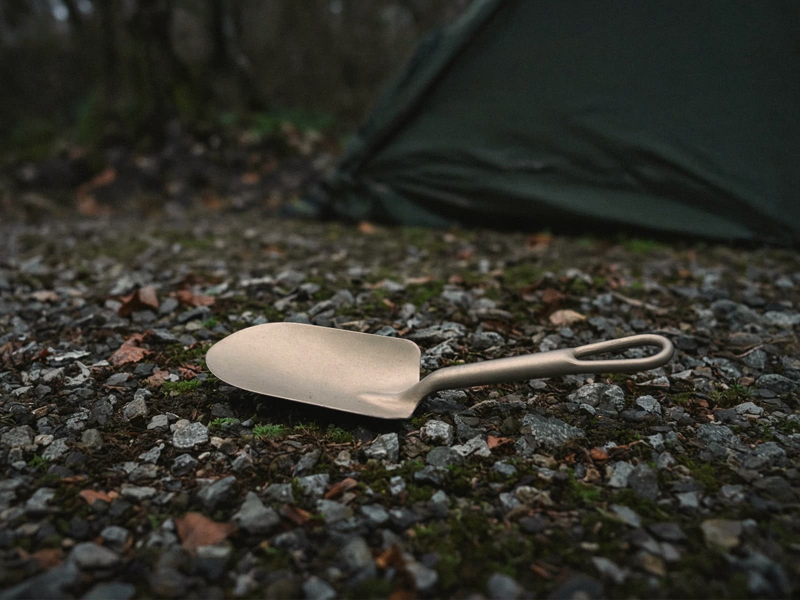 A slim titanium trowel at a car campsite