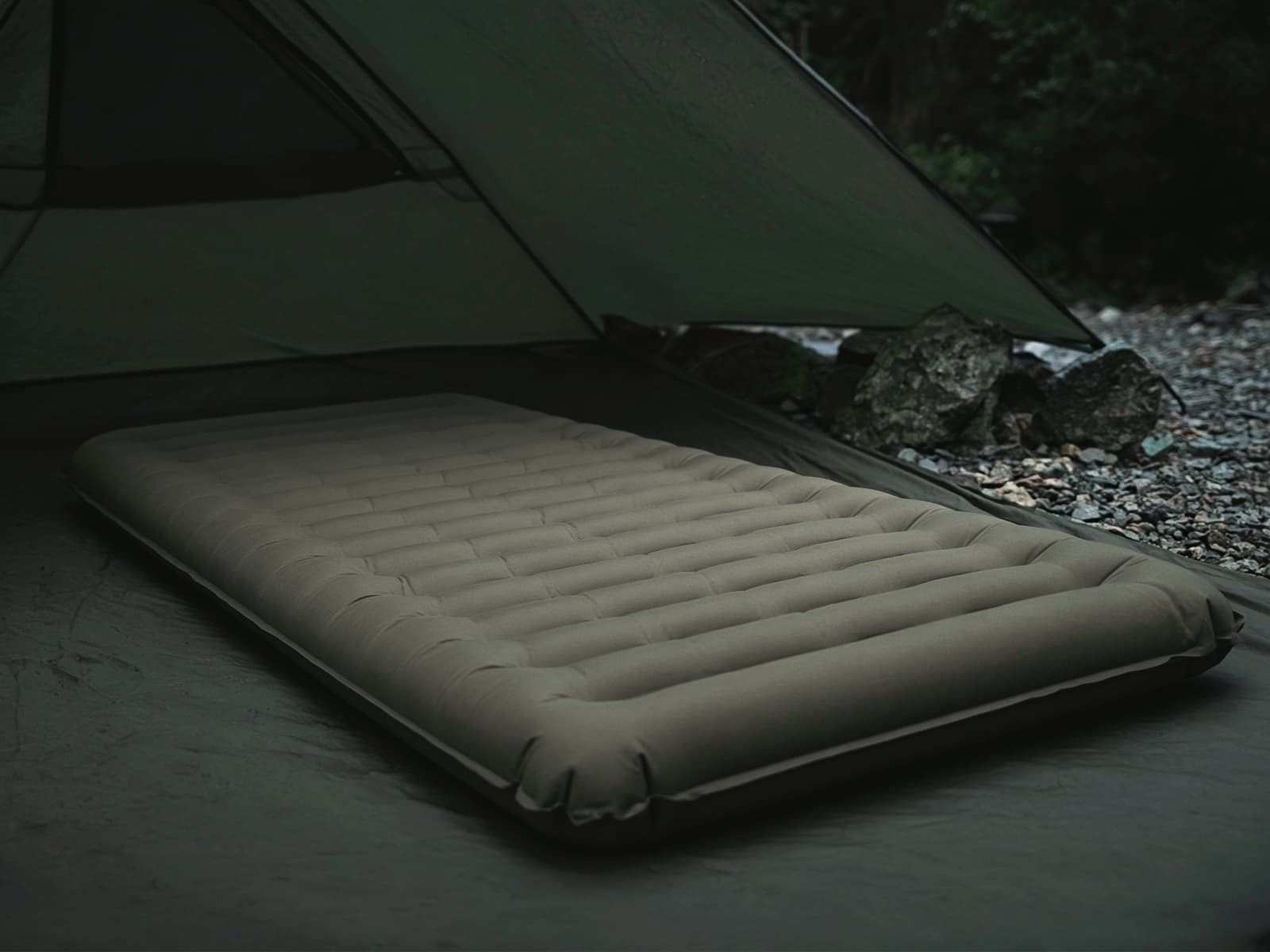 A plush thick air pad on a tent floor