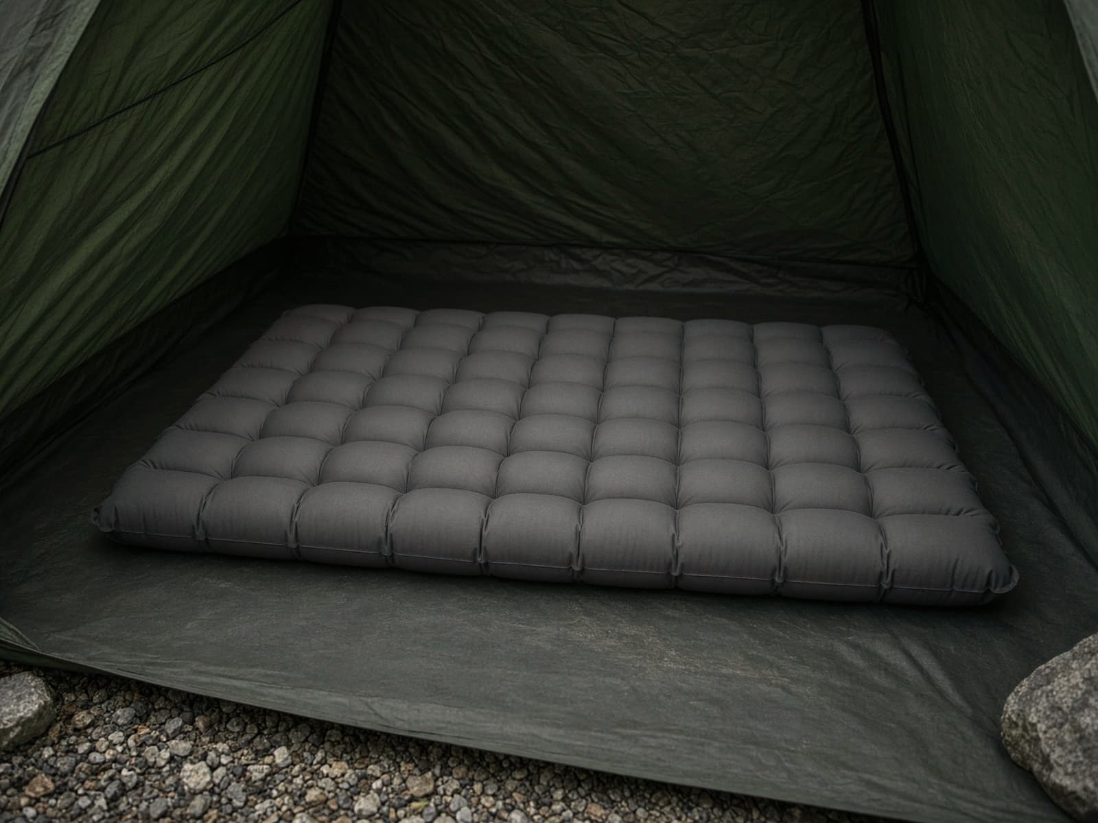 A thick insulated air pad on a tent floor