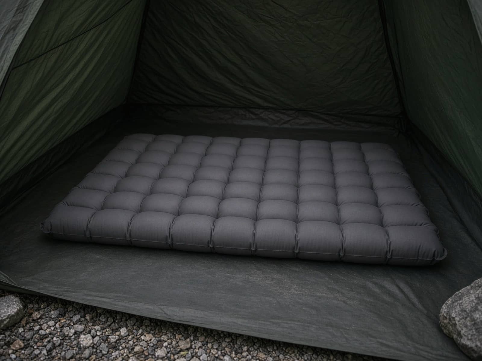 A thick insulated air pad on a tent floor