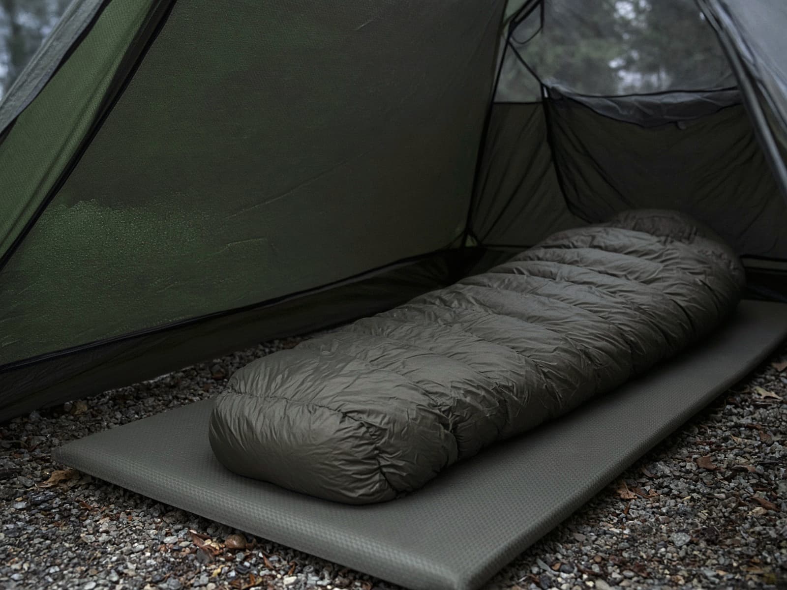 A budget down mummy bag lofted on a pad inside a tent