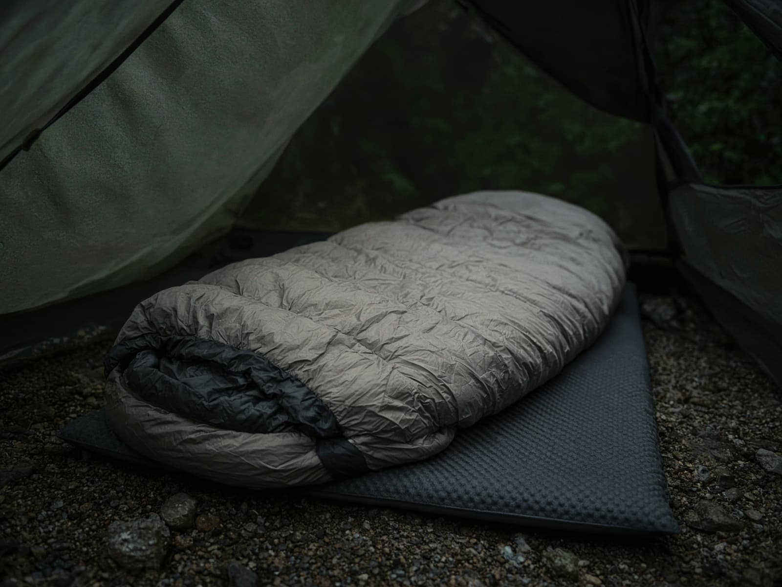 A spoon-shaped down bag lofted on a pad inside a tent