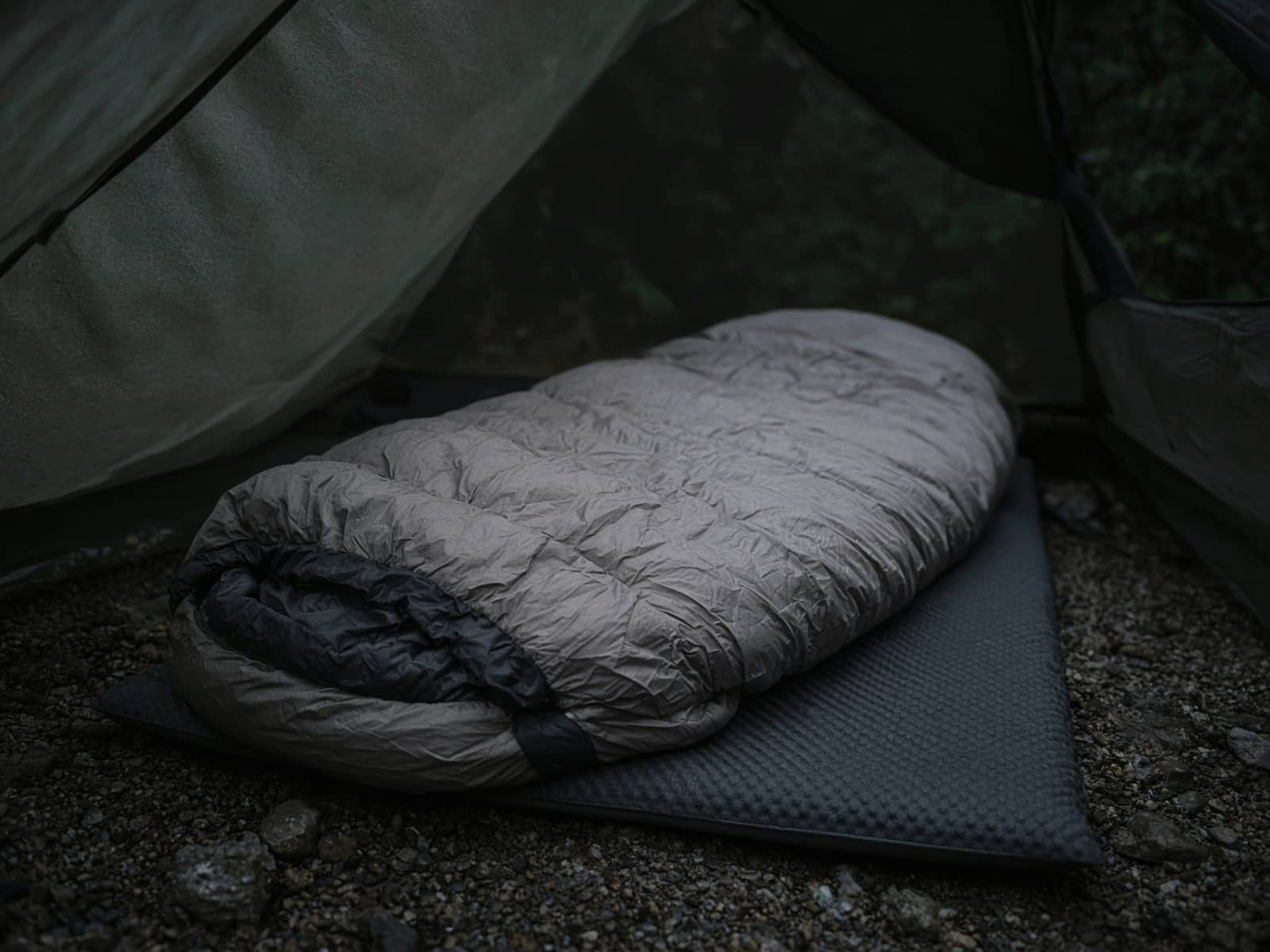 A spoon-shaped down bag lofted on a pad inside a tent