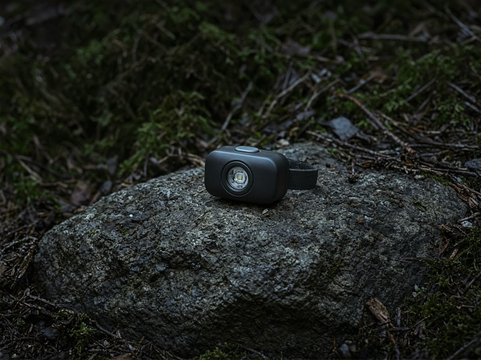 A tiny lightweight headlamp on a rock at blue hour