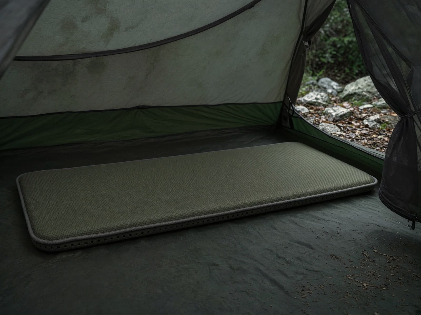 A self-inflating foam pad on a tent floor