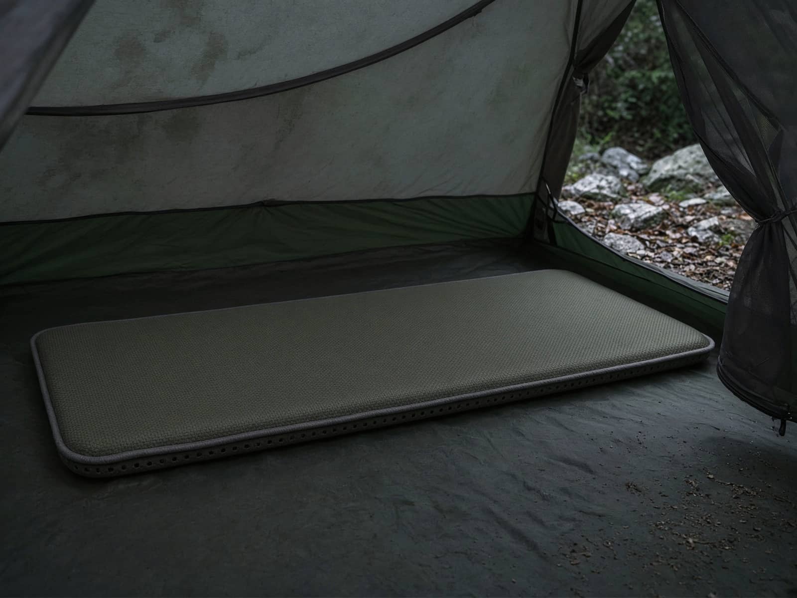 A self-inflating foam pad on a tent floor