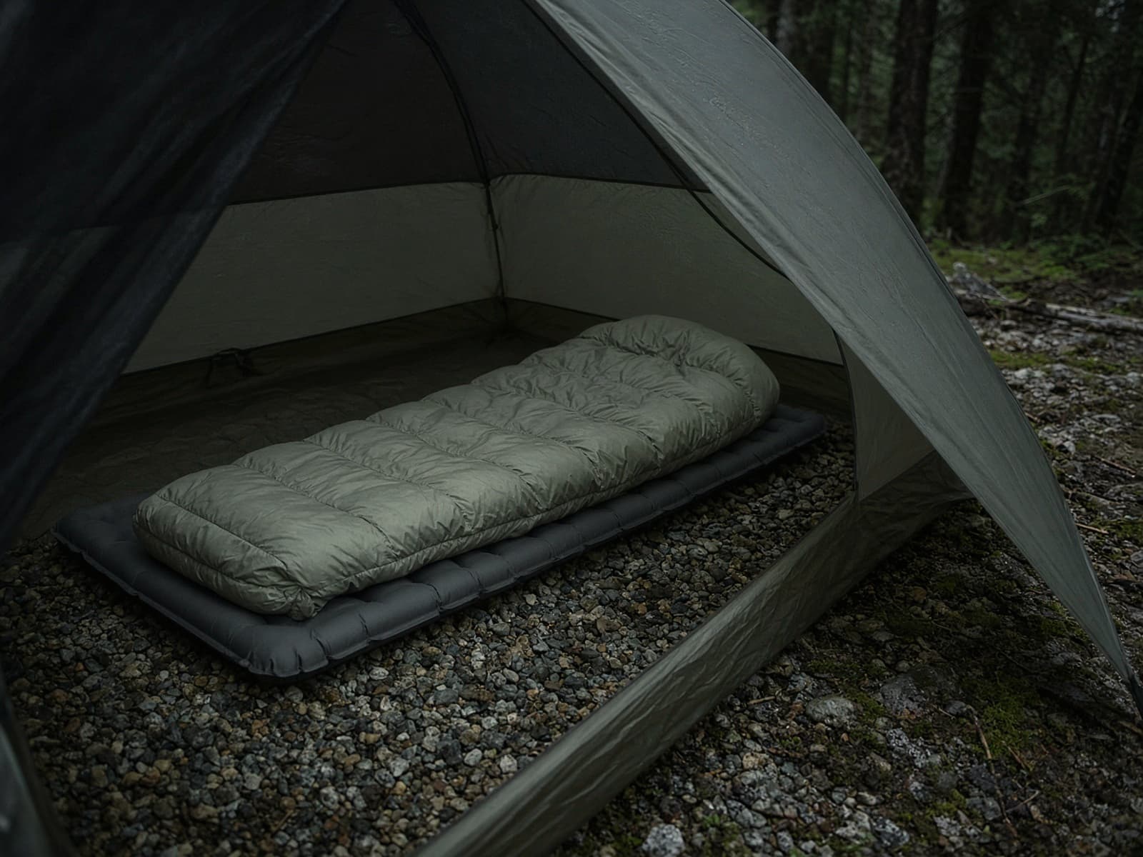A synthetic rectangular-ish sleeping bag lofted on a pad inside a tent