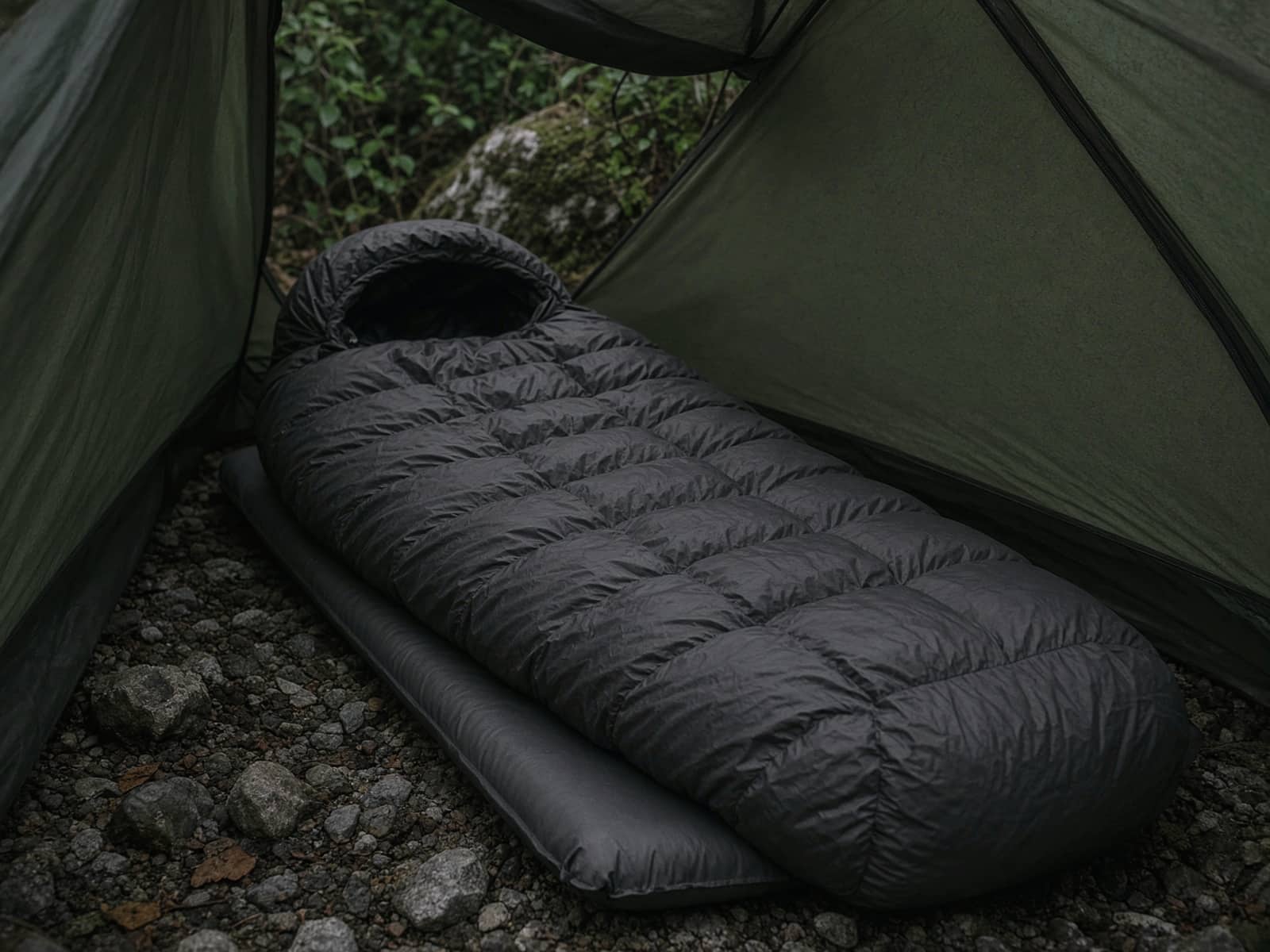 A small-packing ultralight down mummy lofted on a pad inside a tent