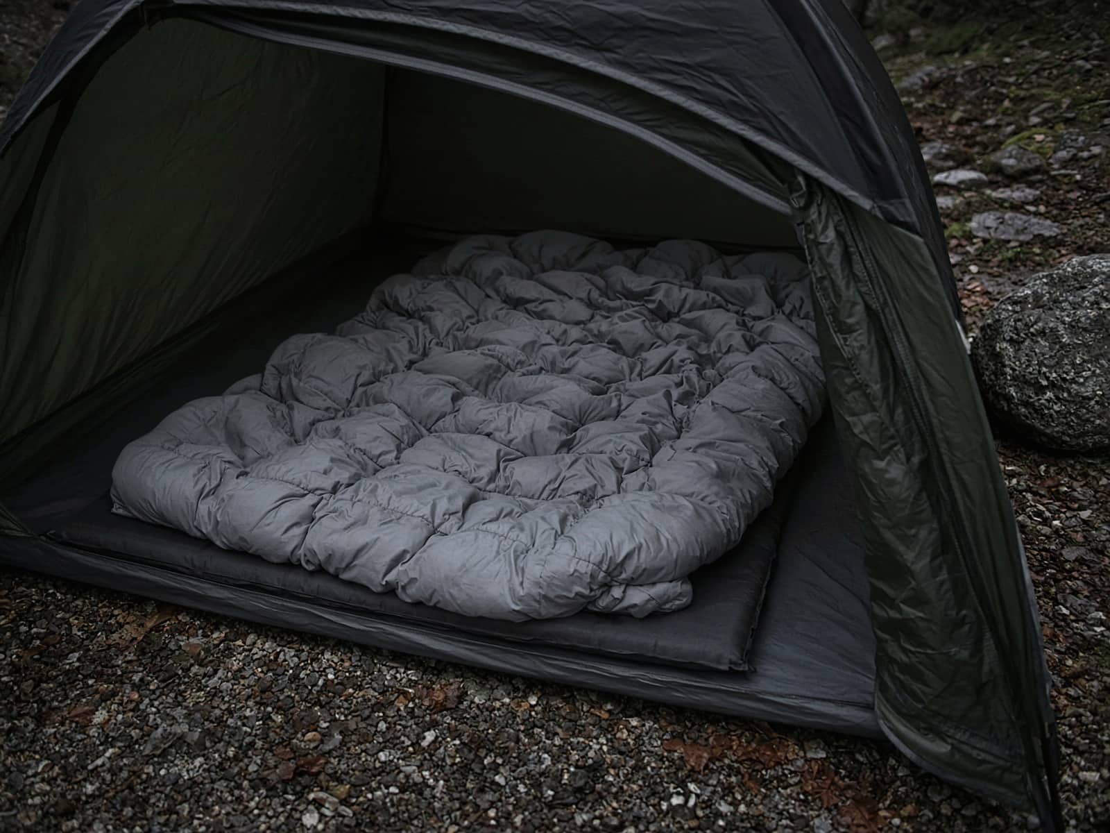 A budget down quilt lofted on a pad inside a tent