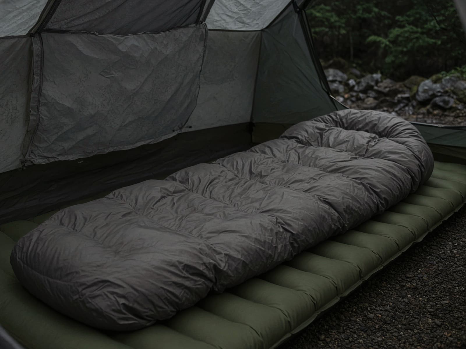 A roomy down sleeping bag lofted on a pad inside a tent