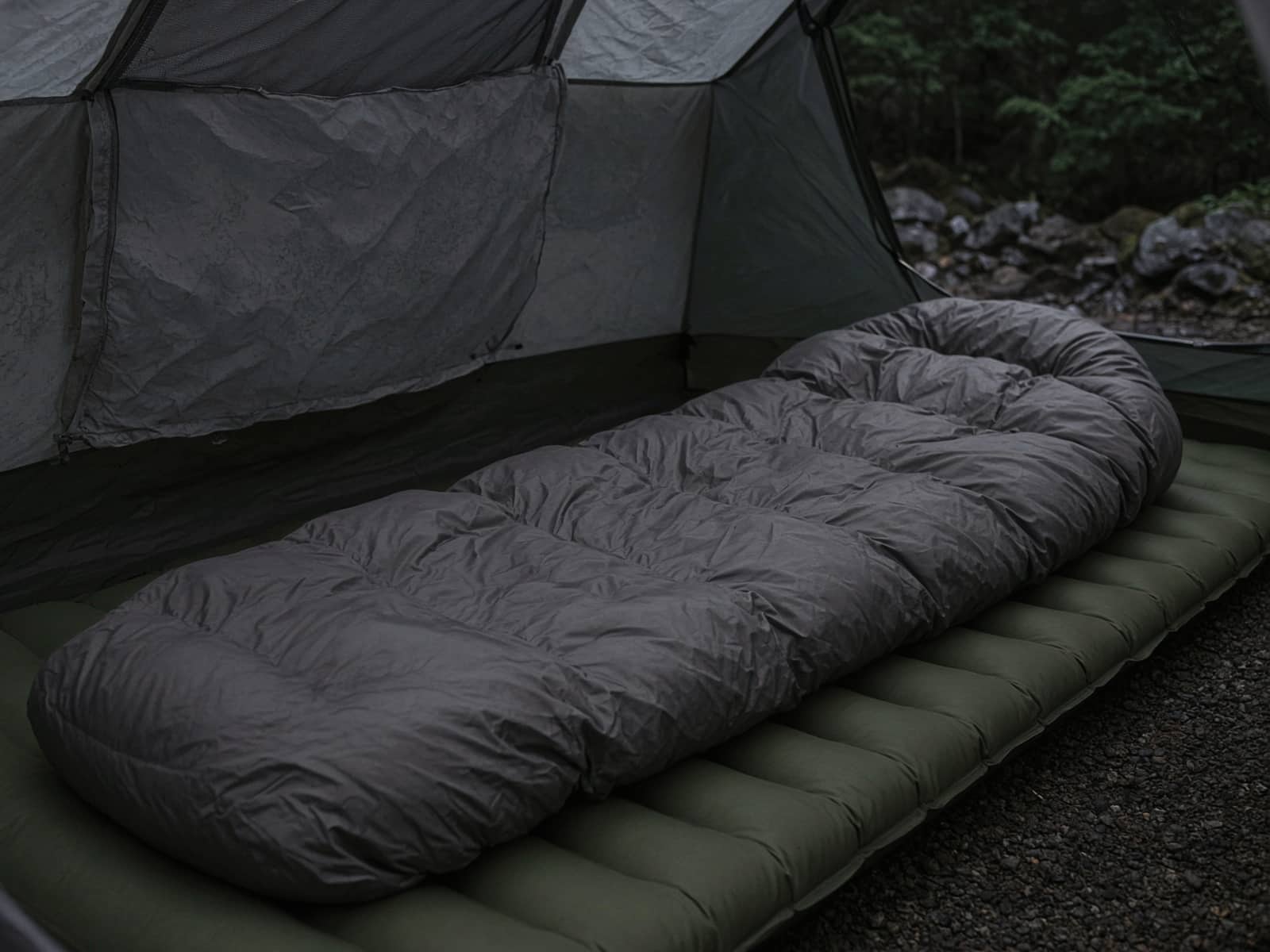 A roomy down sleeping bag lofted on a pad inside a tent