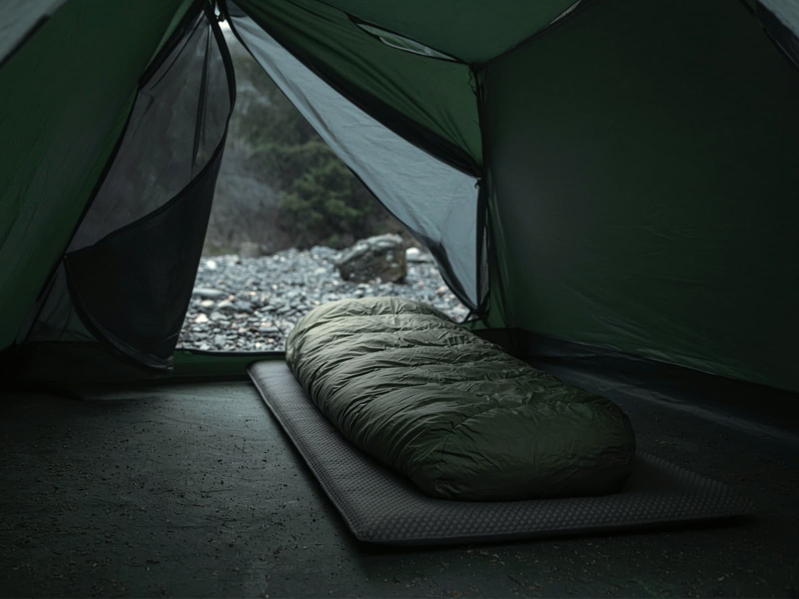 A synthetic mummy bag lofted on a pad inside a tent