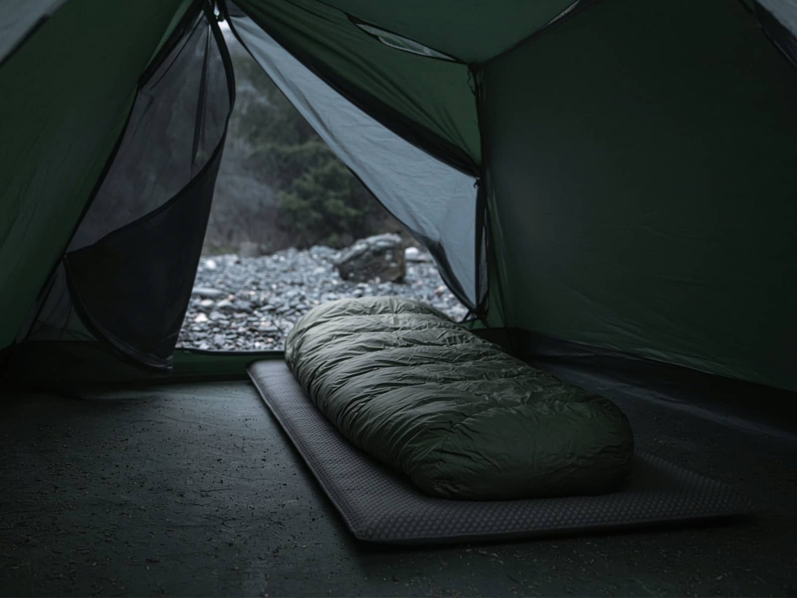 A synthetic mummy bag lofted on a pad inside a tent