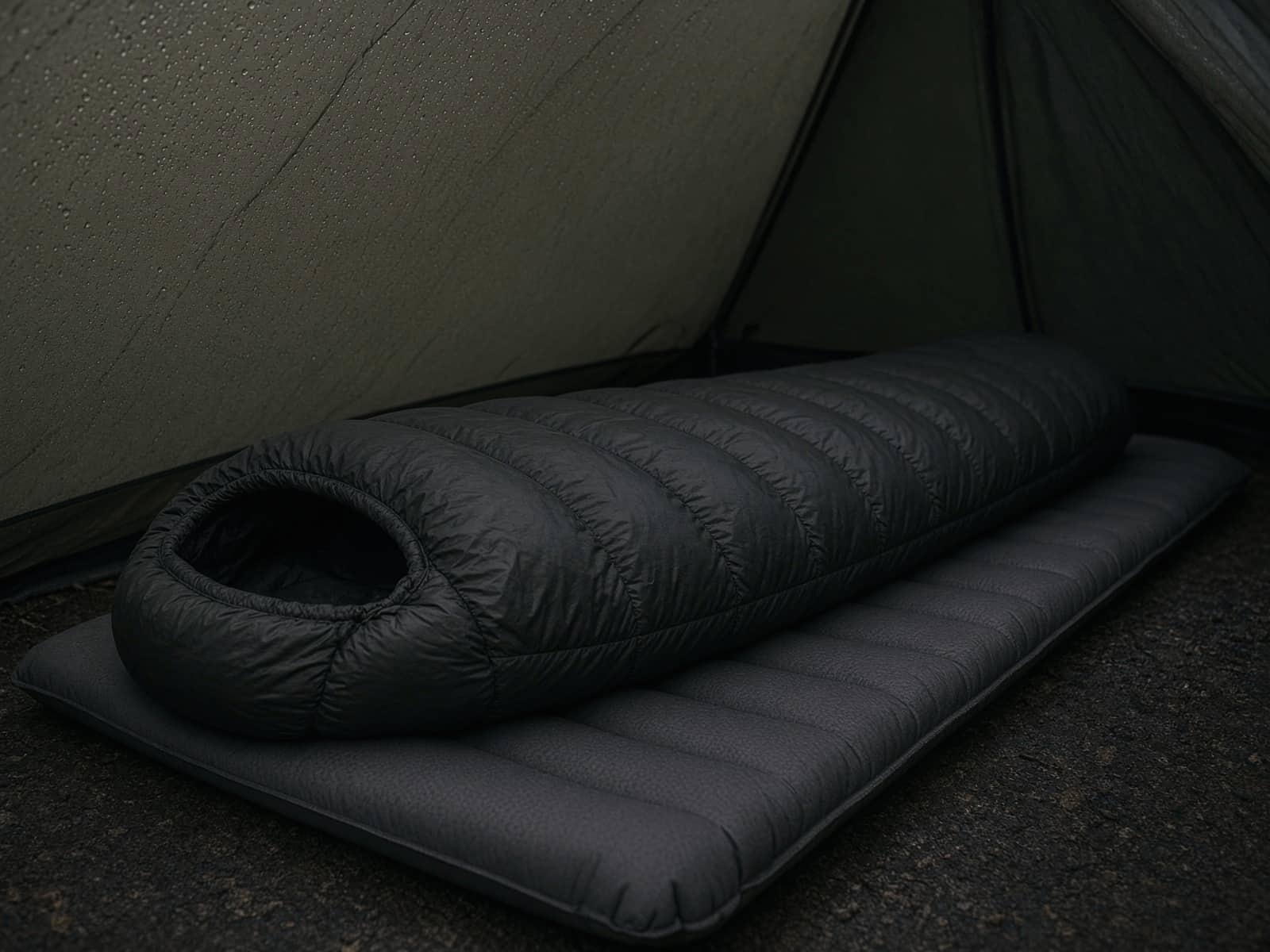 A premium narrow down mummy bag lofted on a pad inside a tent