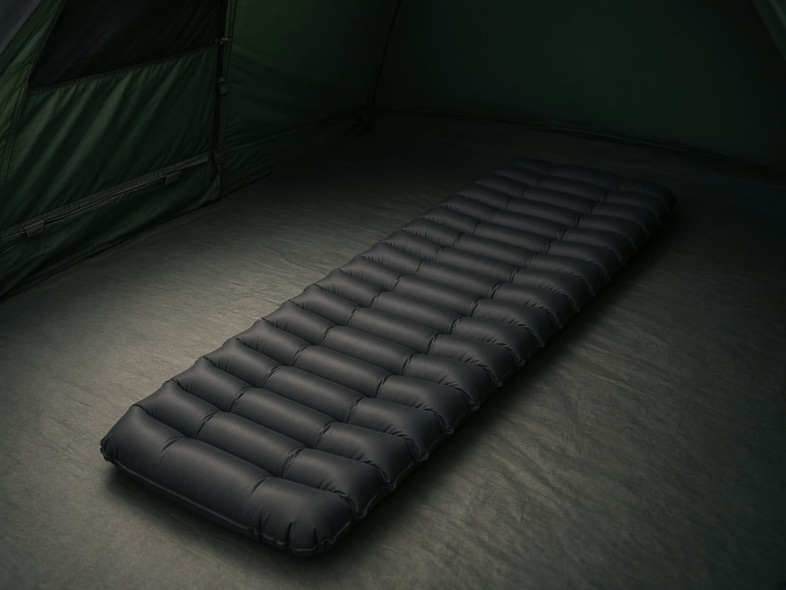 A tapered mummy air pad on a tent floor