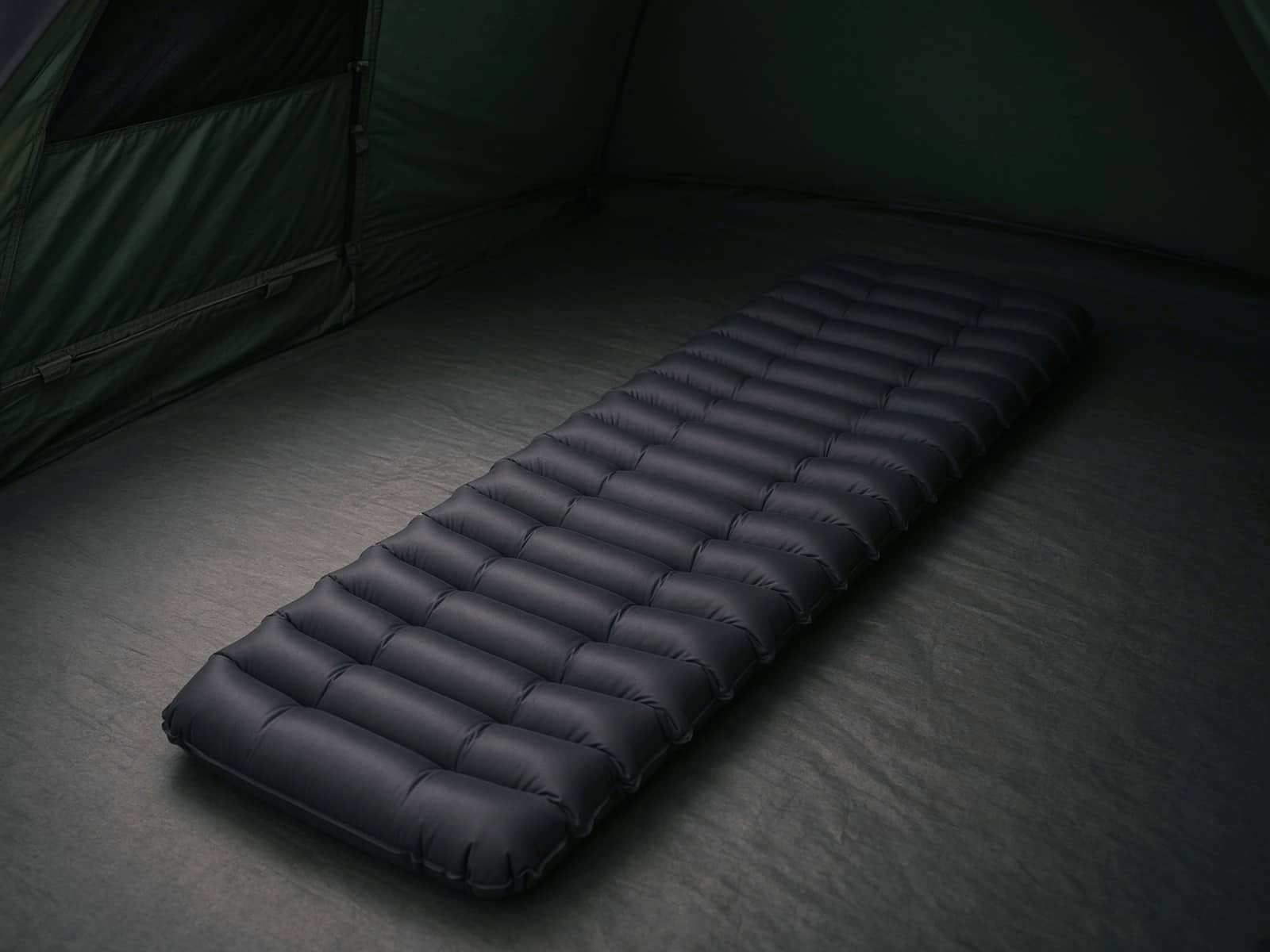 A tapered mummy air pad on a tent floor
