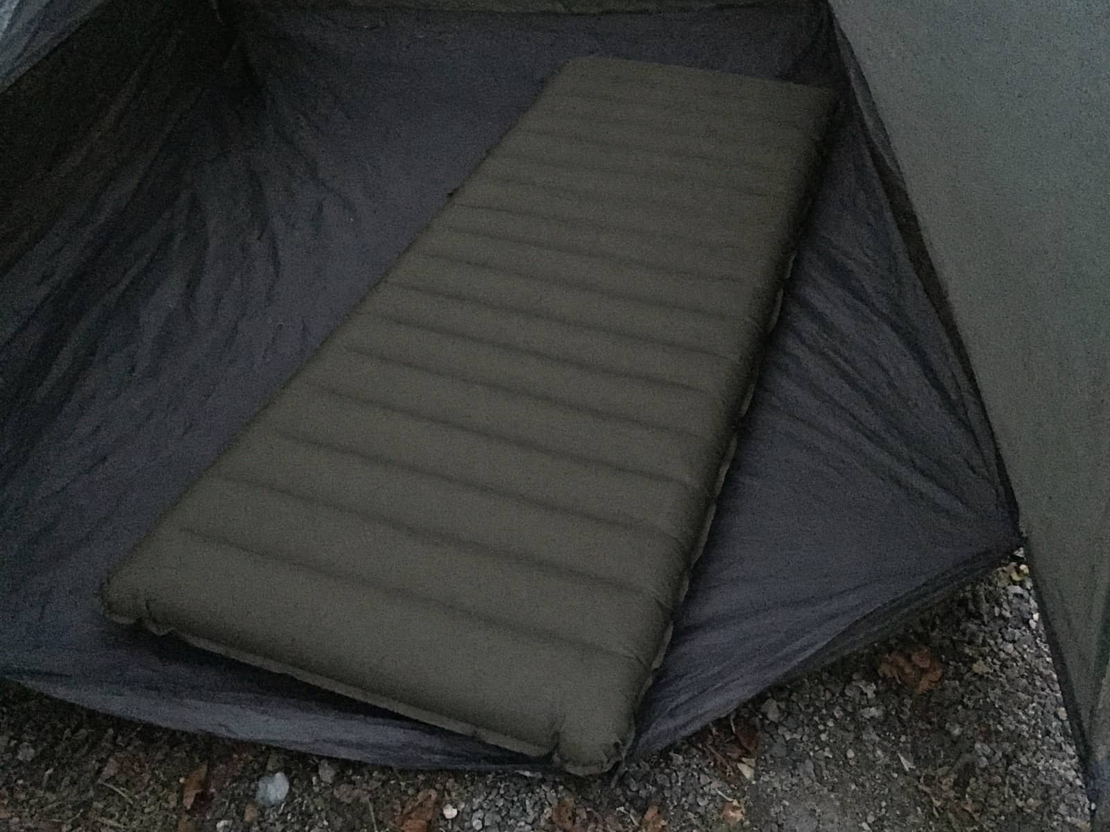A wide tapered air pad on a tent floor