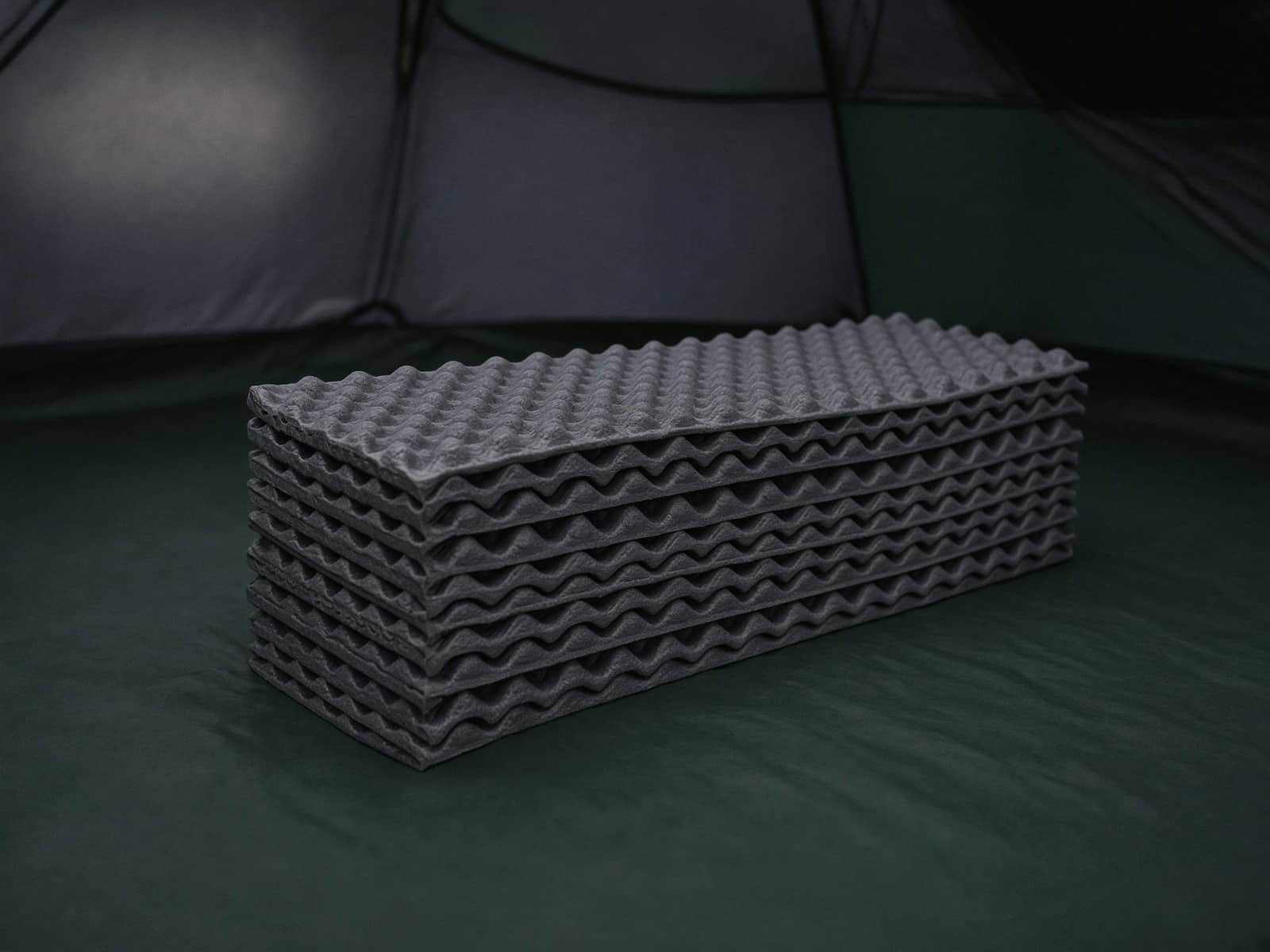 A folded accordion closed-cell foam pad on a tent floor